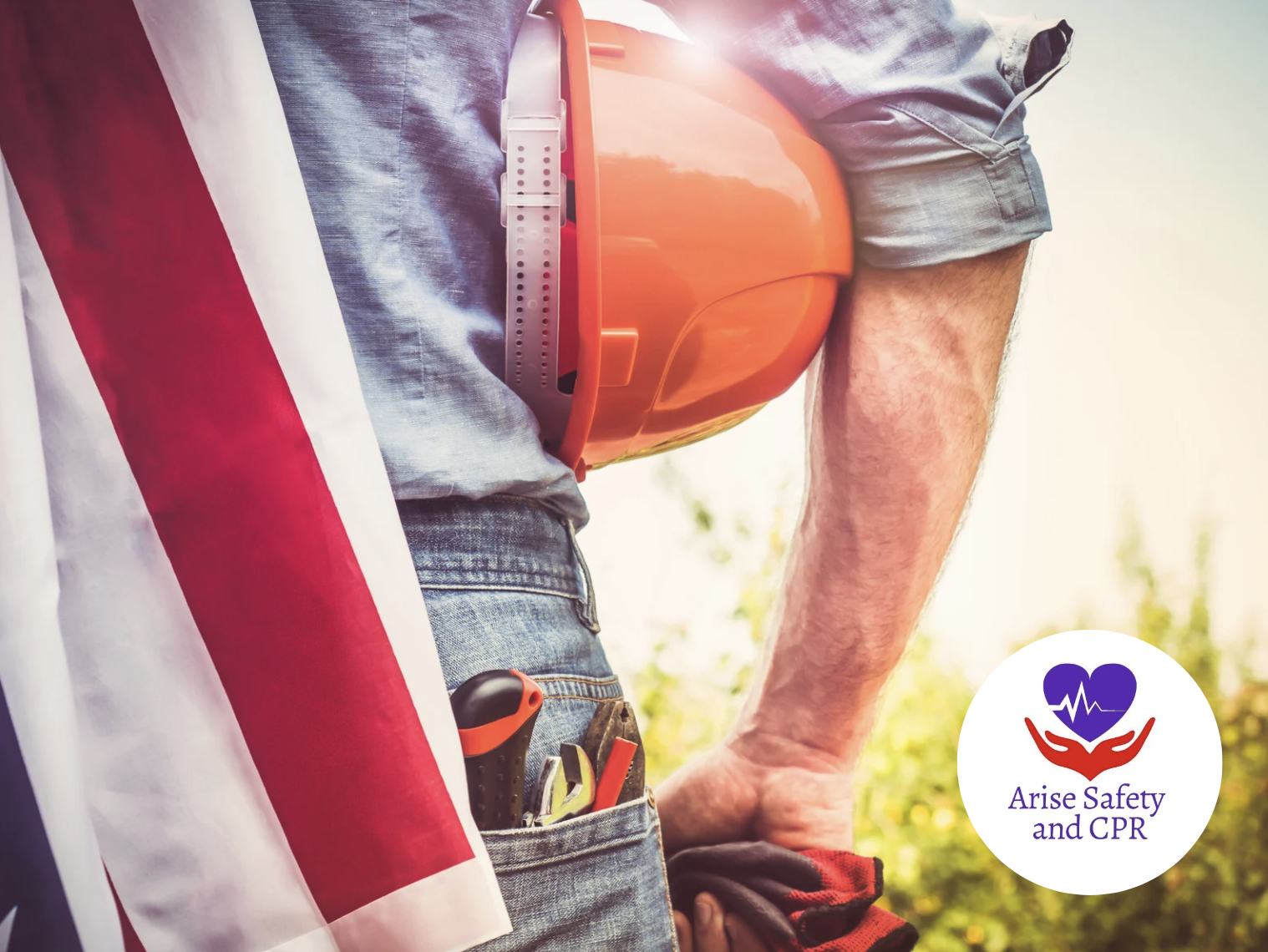 Man facing towards a field, holding a hard hat with tools in his back pocket and an American Flag draped over his shoulder. Happy Labor Day